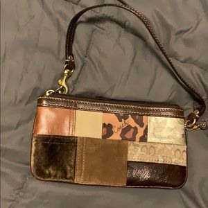 Coach wristlet with mixed designs and textures